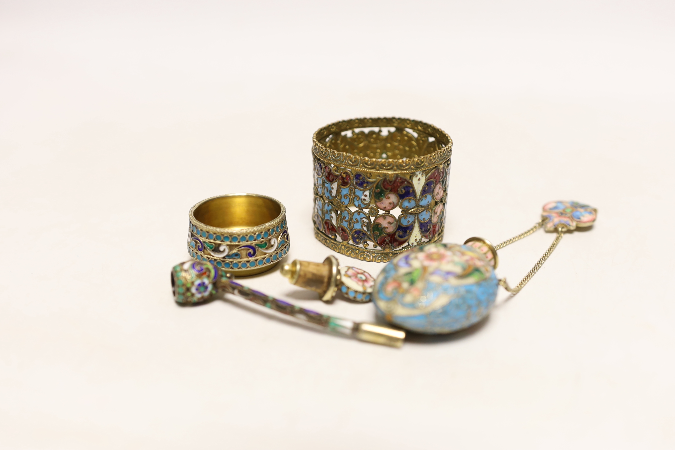 A late 19th/early 20th century Russian gilt 84 zolotnik and polychrome enamel pipe, 73mm, similar later scent bottle and salt and a brass? and enamelled napkin ring.